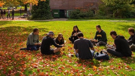 Students in cirlce on lawn