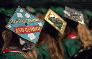 Student at commencement with a mortarboard that says To Graduate School and Beyond
