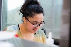Dristi Manandhar, a UO grad student pursuing her master's in architecture from Nepal, working on a computer
