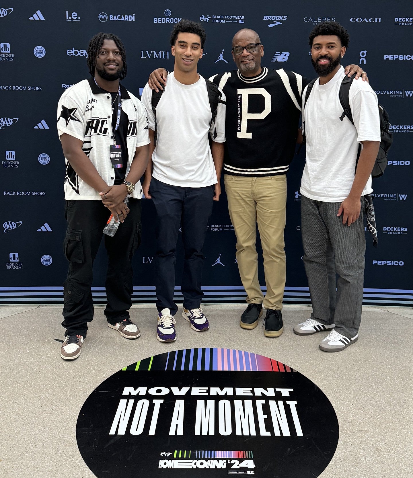 Jalen Niles, Jordan Edmond, and Toluwalase Adedipe with Dr. D'Wayne Edwards, founder of the Black Footwear Forum.