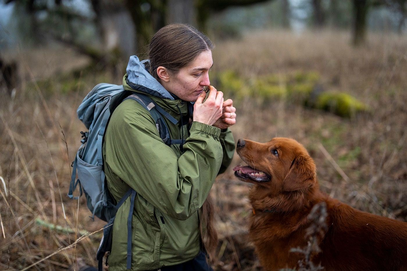 Heather Dawson smelling a truffle with her dog, Rye.