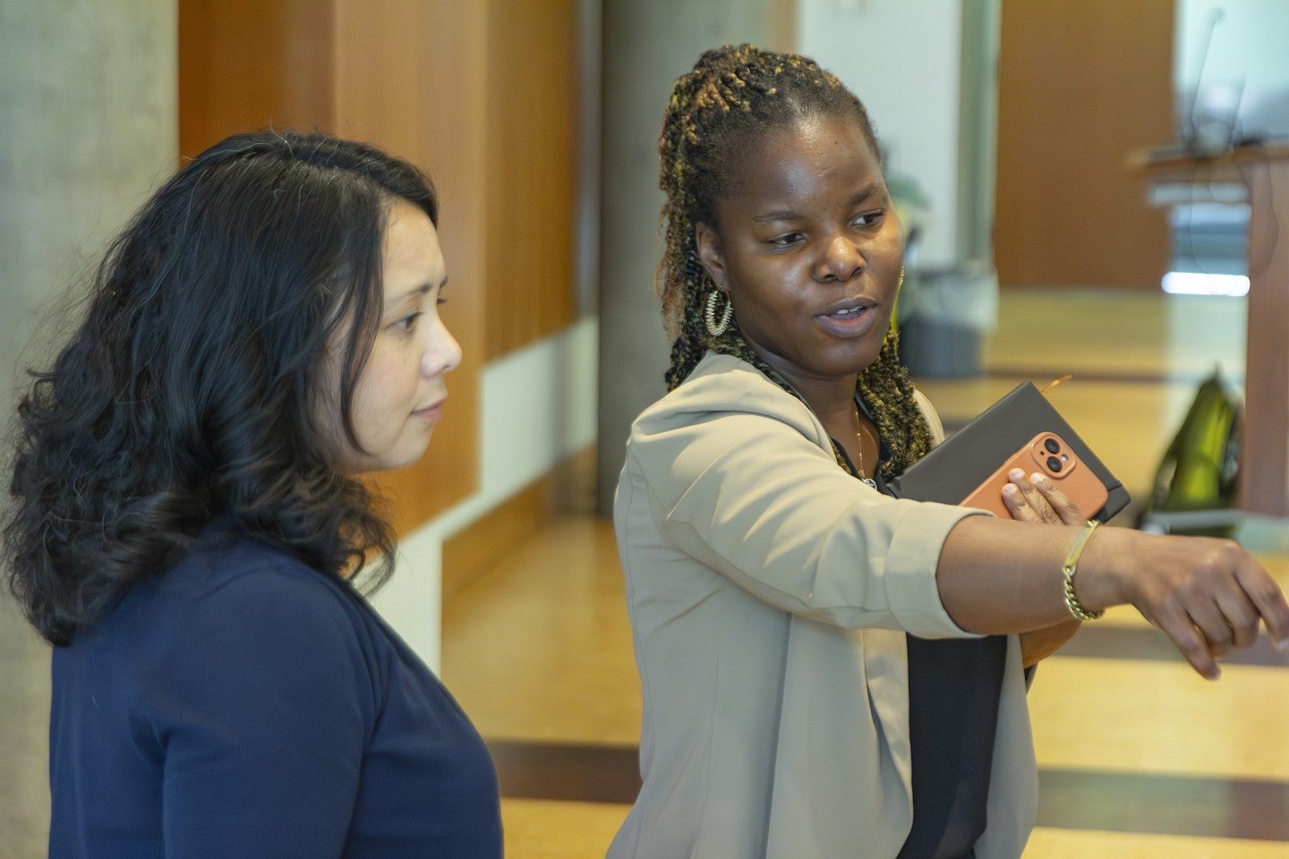 A doctoral student presents a research poster.