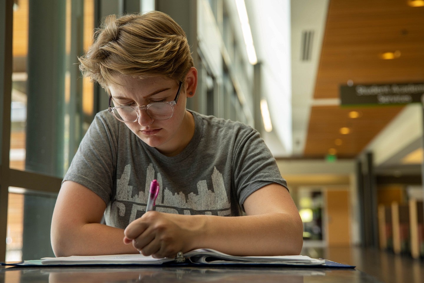 A student writing in a notebook.