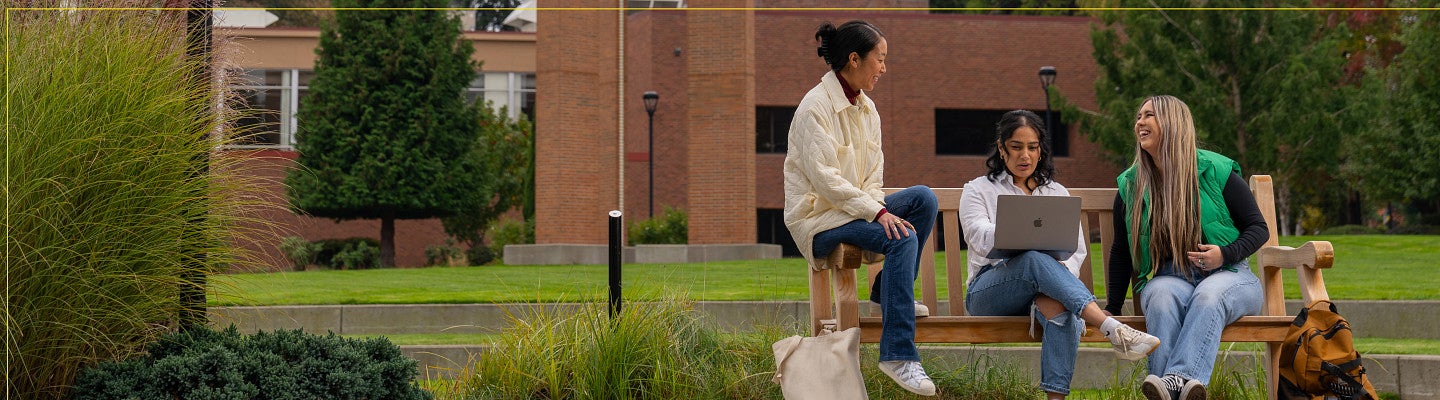 Three students sit together on the UO PDX campus.