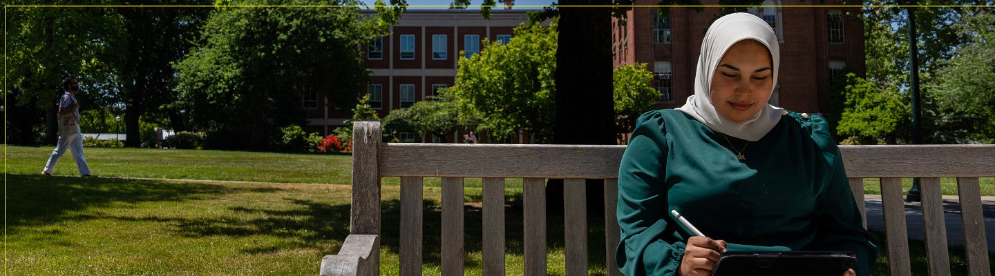 Student working on a bench on campus.