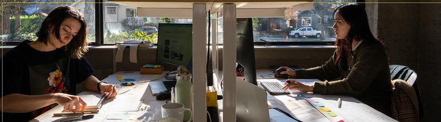 Two students working at desks.
