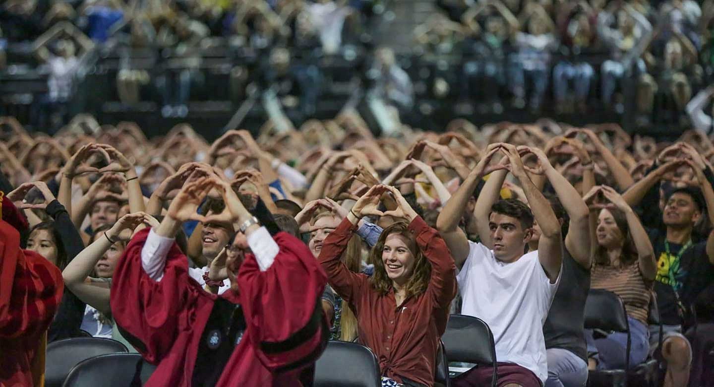 People throwing the O in Matt Knight Arena