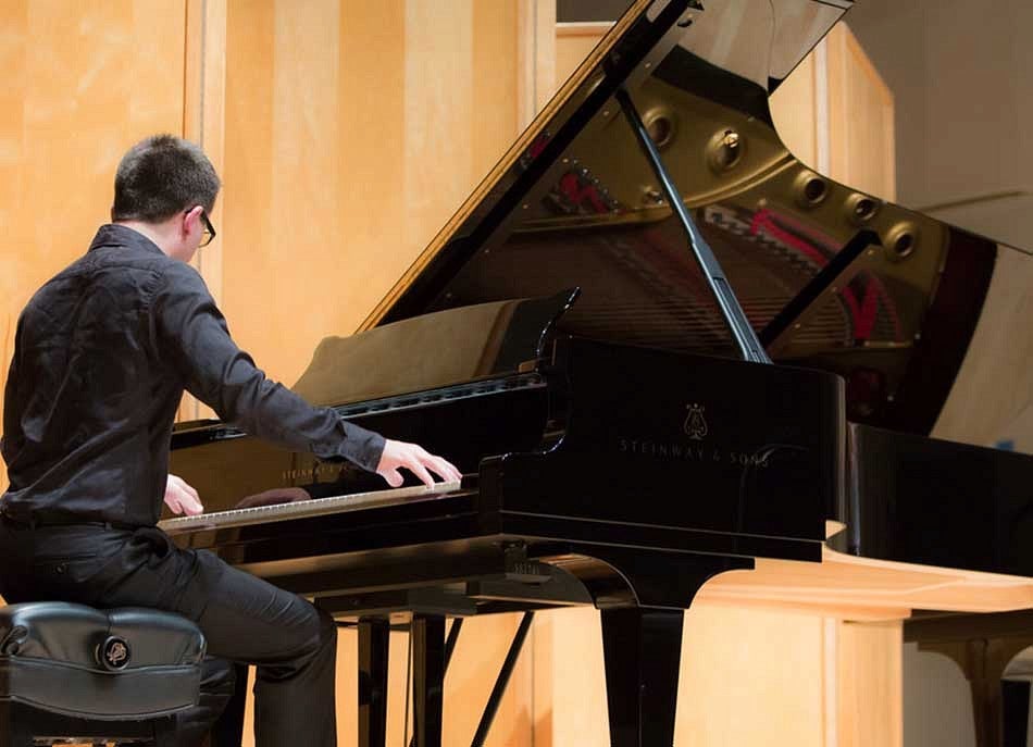 A person playing a piano on a stage