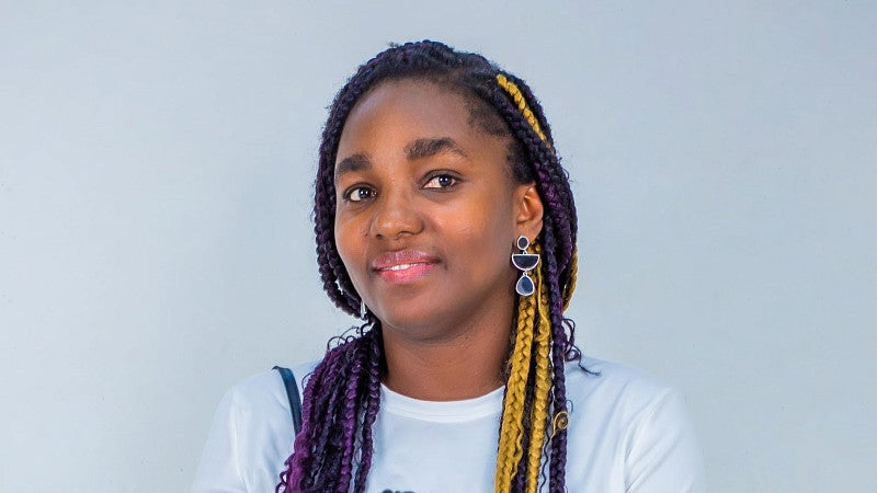 Rhodalyn Tetteh has long braids that are black, gold, and purple.