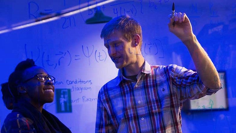 A male professor working with a female student A male professor working with a female student