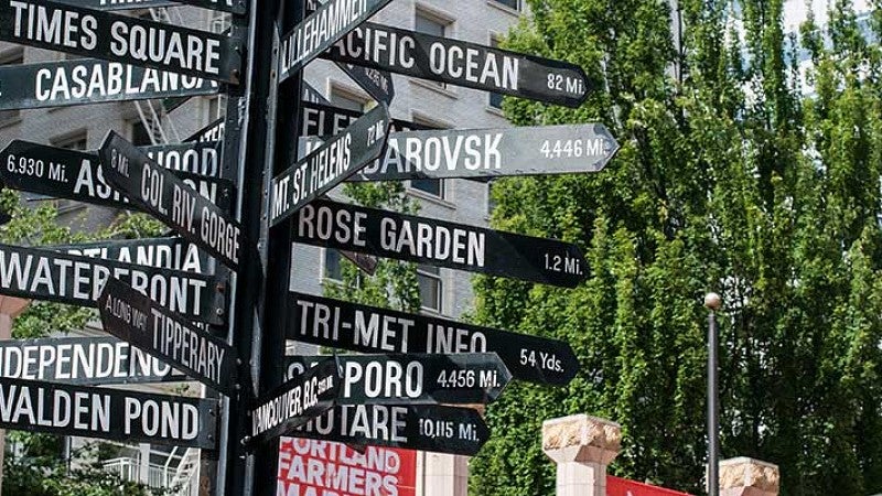 Sign showing travel distances in miles from Portland