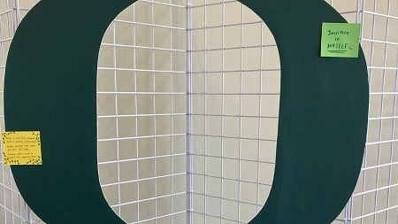 Green Oregon O on a wire frame.