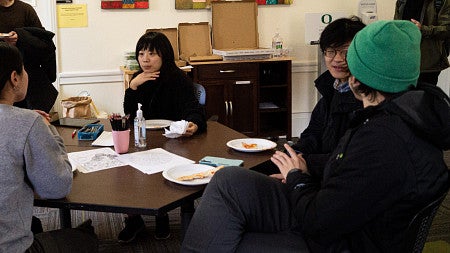 International graduate students talking to each other in a comfortable setting