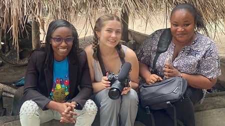 Rachel Marty, master's candidate in strategic communications, holds a camera.