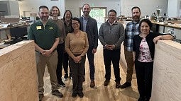Division staff standing together on the UO PDX campus.