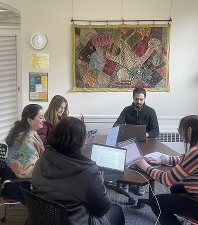 Graduate Students writing together at a table