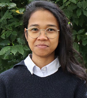 Feni Kurniati has long dark hair and glasses.