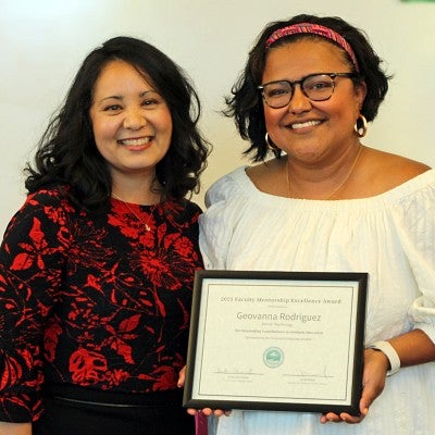 Geovanna Rodriguez accepts excellence award from Vice Provost Krista Chronister