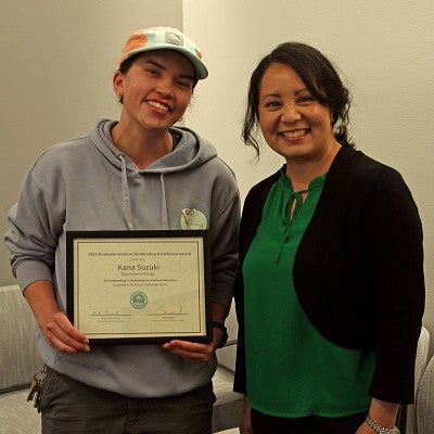 Kana Suzuki accepts excellence award from Vice Provost Krista Chronister
