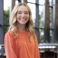 Smiling person with blonde hair.