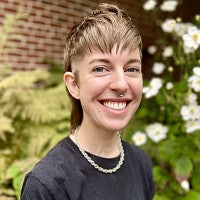 Hales Wilson has short brown hair and is wearing a black tee.